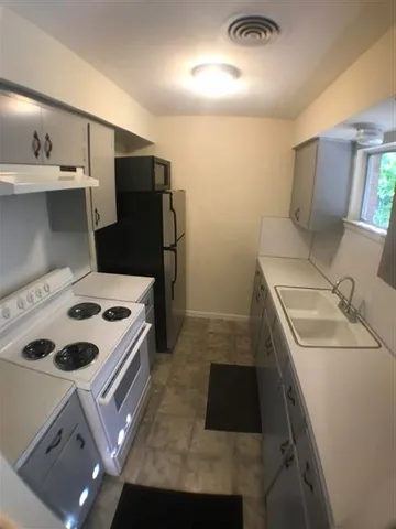 a kitchen that has a sink and a stove