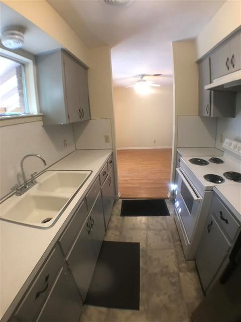 2310 Rebel Road, Unit B Austin, TX 78704 - Photo 7 of 13 a kitchen with a sink stove and cabinets