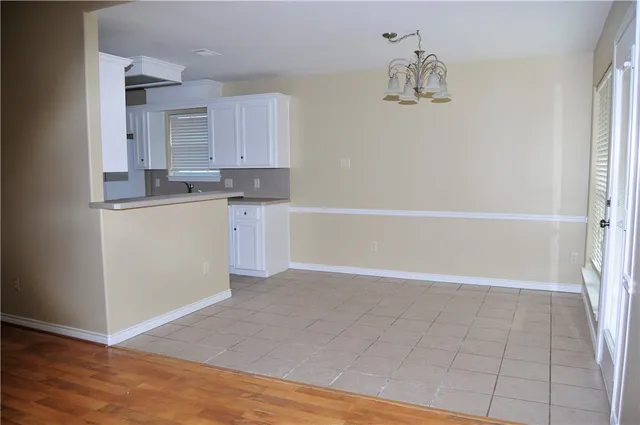 a view of kitchen with granite countertop cabinets and wooden floor