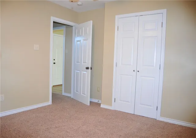 a view of an empty room with closet area