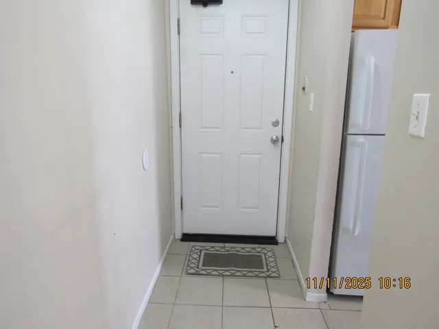 a kitchen with stainless steel appliances granite countertop a stove a refrigerator a sink dishwasher and wooden cabinets with wooden floor