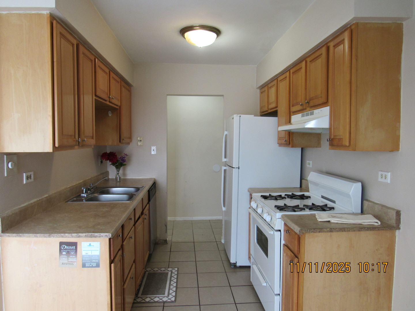 1156 Copperfield Lane, Unit E Schaumburg, IL 60193 - Photo 3 of 13 a kitchen with stainless steel appliances granite countertop a stove a refrigerator a sink dishwasher and wooden cabinets with wooden floor