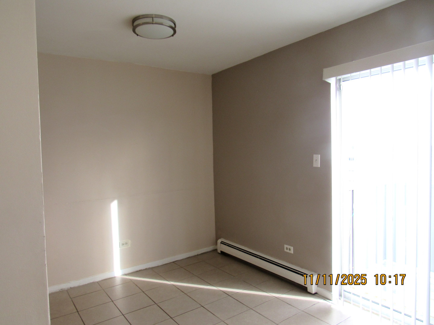 1156 Copperfield Lane, Unit E Schaumburg, IL 60193 - Photo 6 of 13 a view of an empty room and window