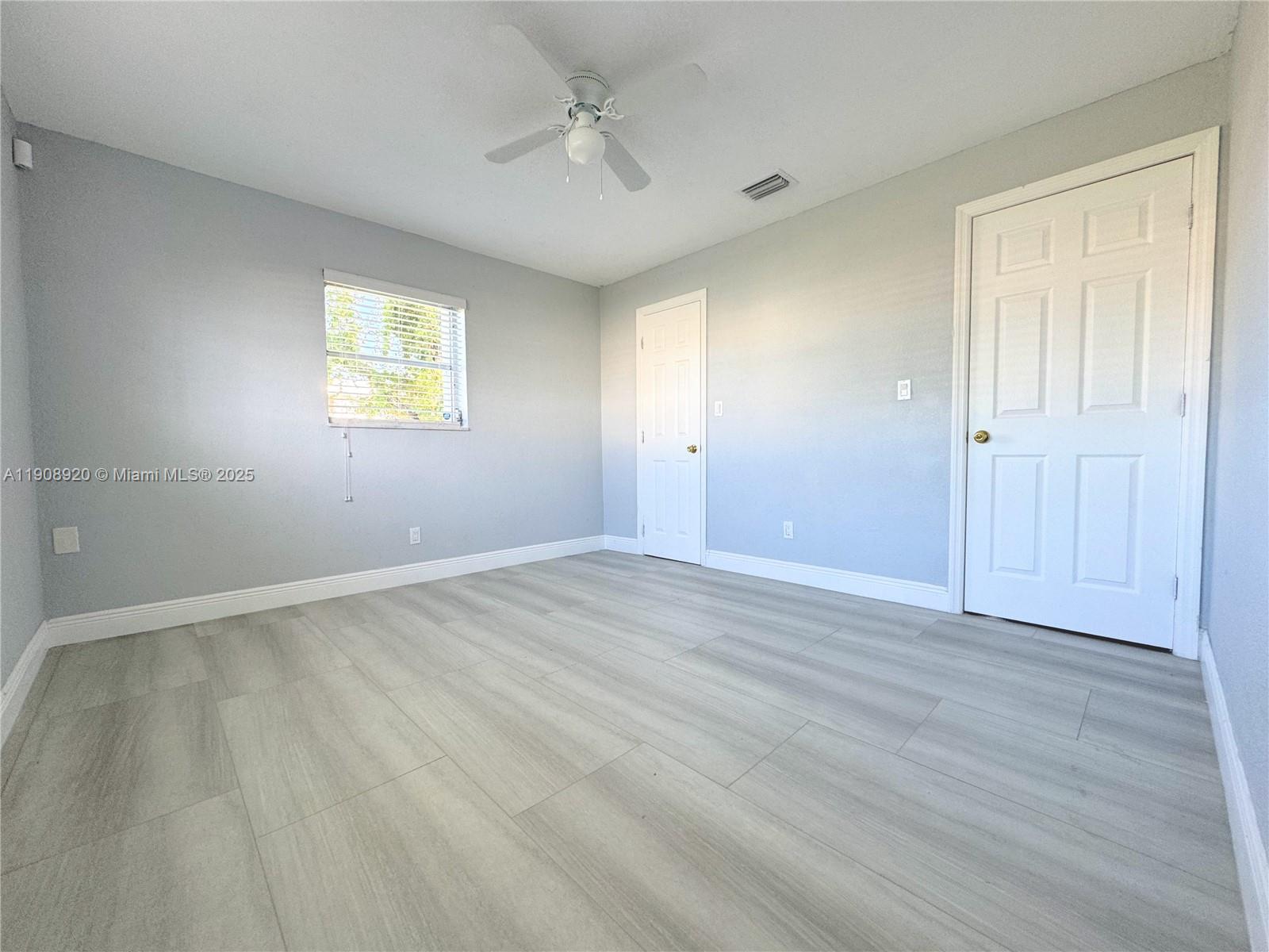 300 Northwest 28th Court Pompano Beach, FL 33064 - Photo 14 of 30 wooden floor in an empty room with a window
