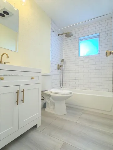 a bathroom with a sink a toilet and a bathtub