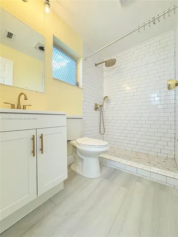 a bathroom with a toilet sink and shower