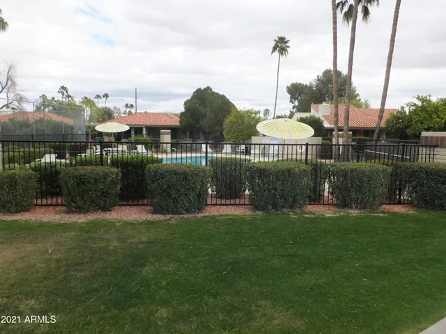 a front view of a house with a yard and a garden