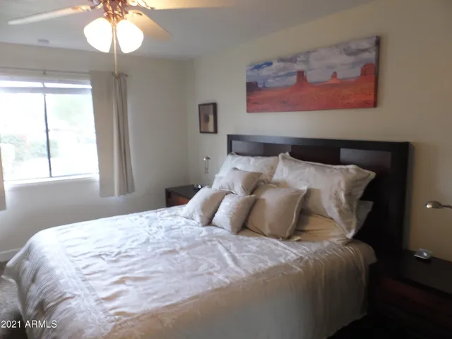 a bedroom with bed and a chandelier
