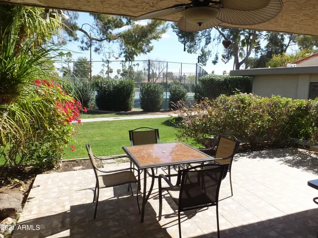 a view of a chairs and table in the patio
