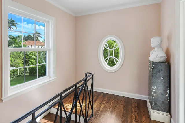 a bathroom with a granite countertop sink a toilet a mirror and window