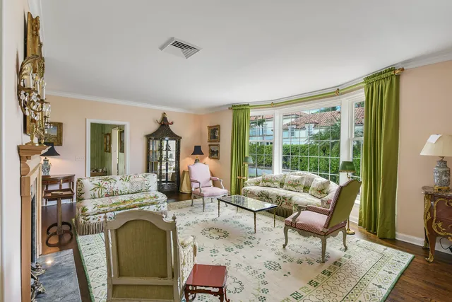 a living room with fireplace furniture and a floor to ceiling window