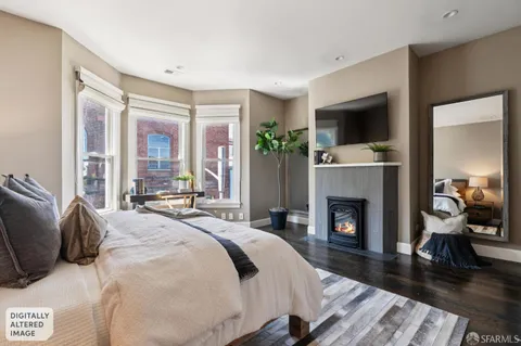 a spacious bedroom with a bed and a fireplace