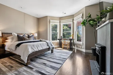 a spacious bedroom with a bed and a potted plant