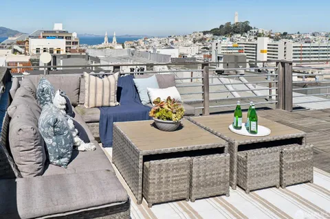 a view of roof deck with furniture