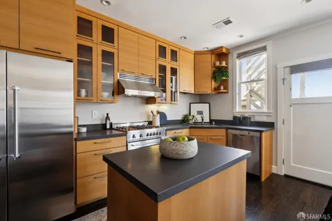 a kitchen with a refrigerator and a sink