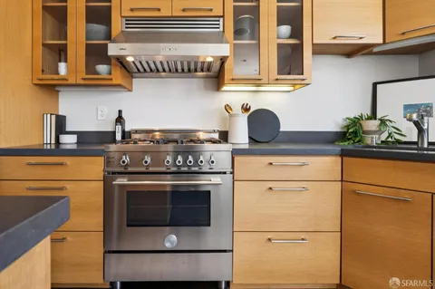 a kitchen with stainless steel appliances granite countertop a stove and a sink