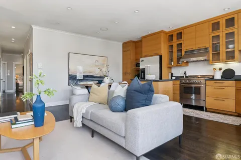 a living room with furniture fireplace and wooden floor