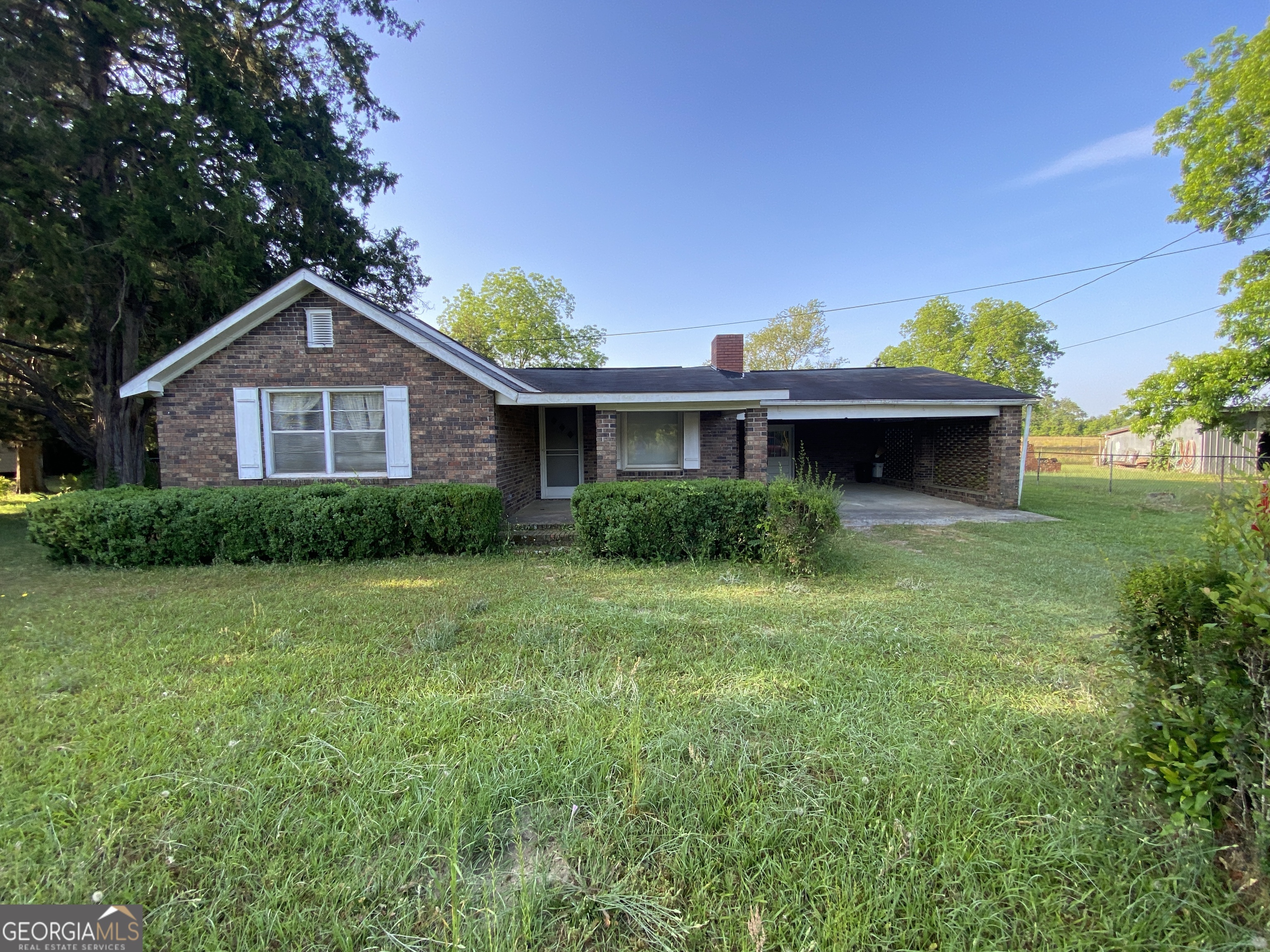 166 Faulk Road Cochran, GA 31014 - Photo 1 of 1 a front view of a house with a garden