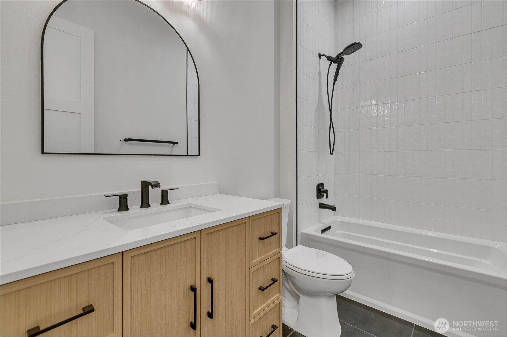 6709 254th Street East Graham, WA 98338 - Photo 28 of 40 a bathroom with a granite countertop toilet sink and mirror