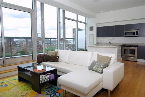 a living room with furniture large windows and a flat screen tv