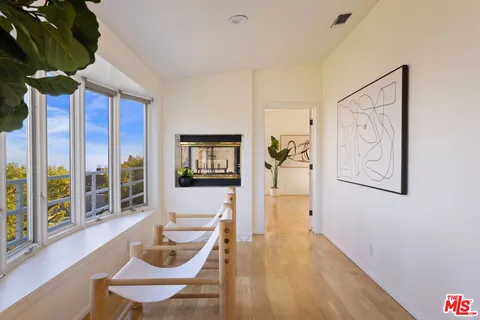 a bedroom with furniture and wooden floor