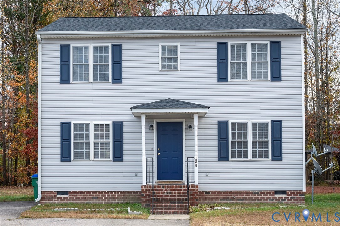 a view of a house with wooden fence and large windows