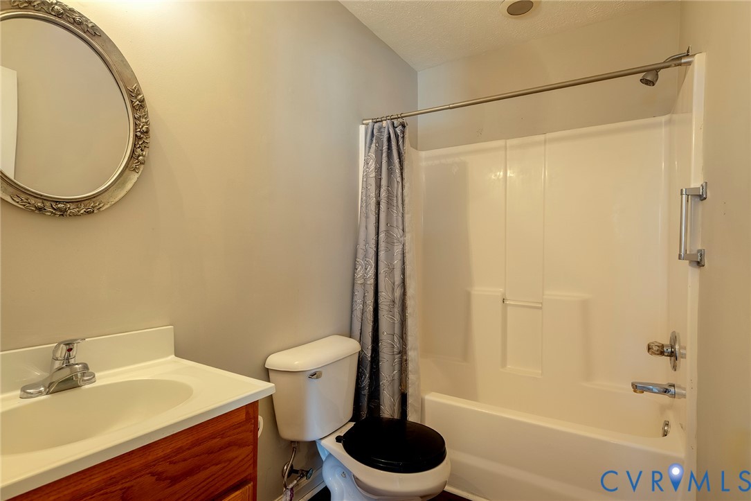 1525 Clarkson Road Richmond, VA 23224 - Photo 12 of 19 a bathroom with a sink a toilet and a mirror