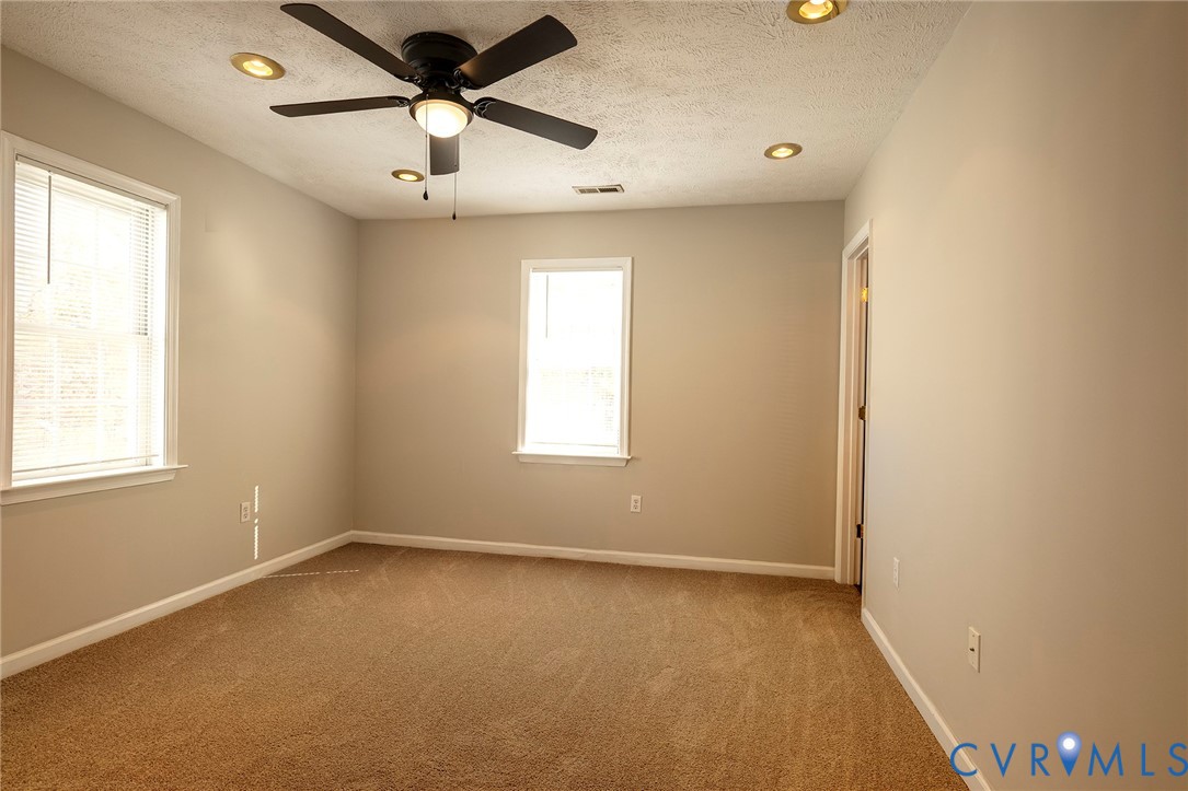 1525 Clarkson Road Richmond, VA 23224 - Photo 15 of 19 an empty room with a window and a fan