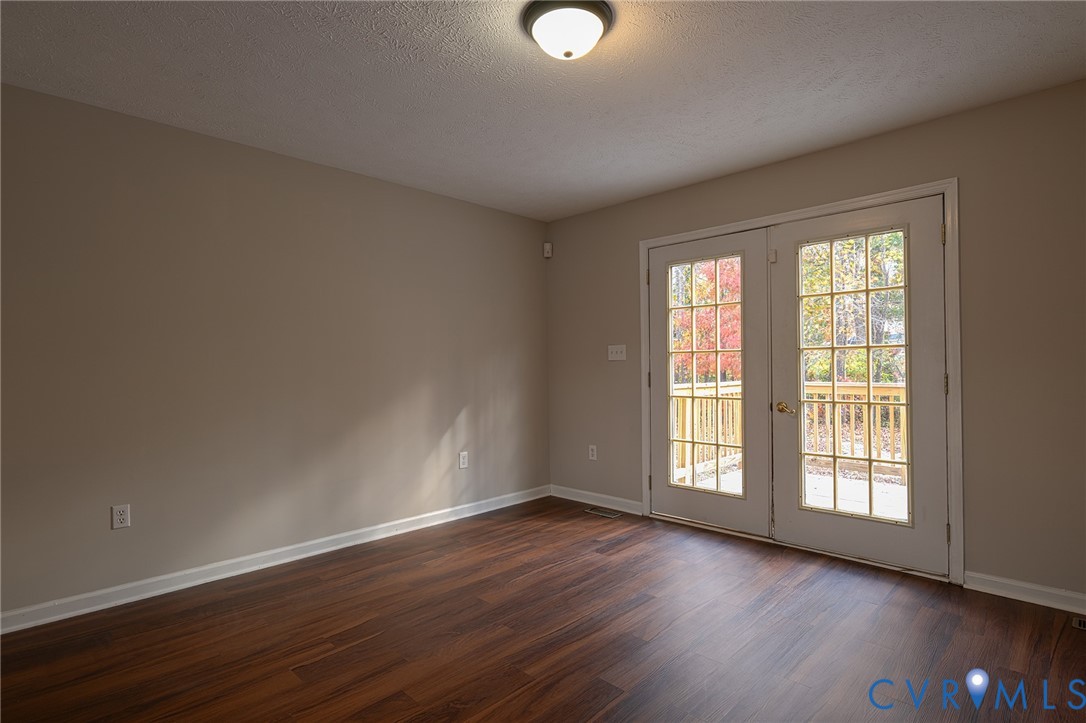 1525 Clarkson Road Richmond, VA 23224 - Photo 6 of 19 a view of an empty room with wooden floor and a window