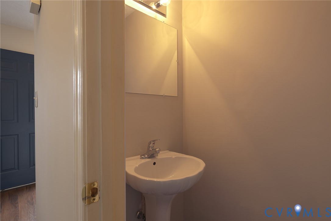 1525 Clarkson Road Richmond, VA 23224 - Photo 8 of 19 a bathroom with a sink and mirror