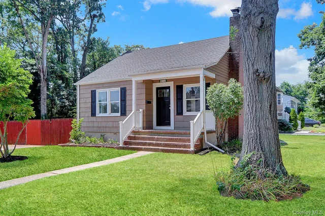 a view of house with backyard