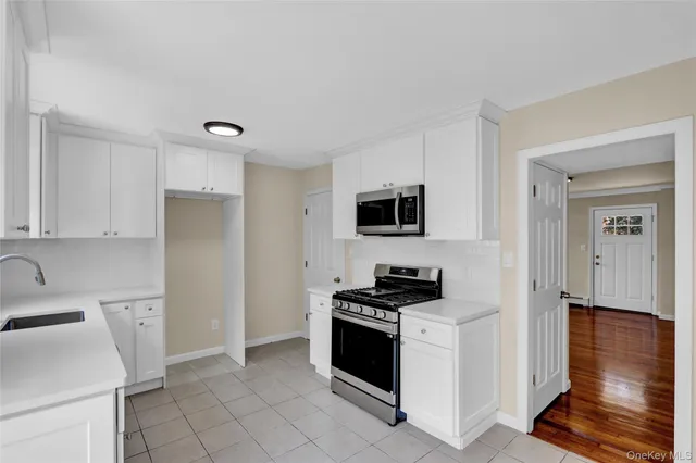 a kitchen with stainless steel appliances a refrigerator sink and stove