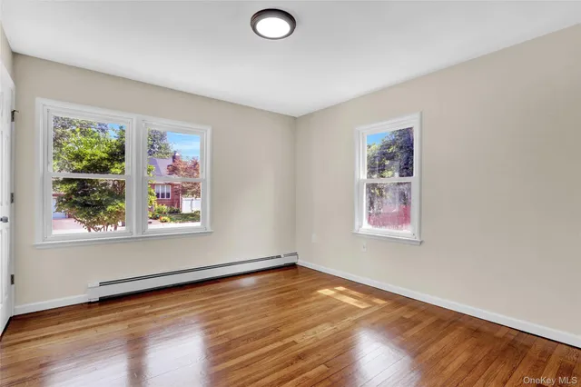 a view of a room with wooden floor and window
