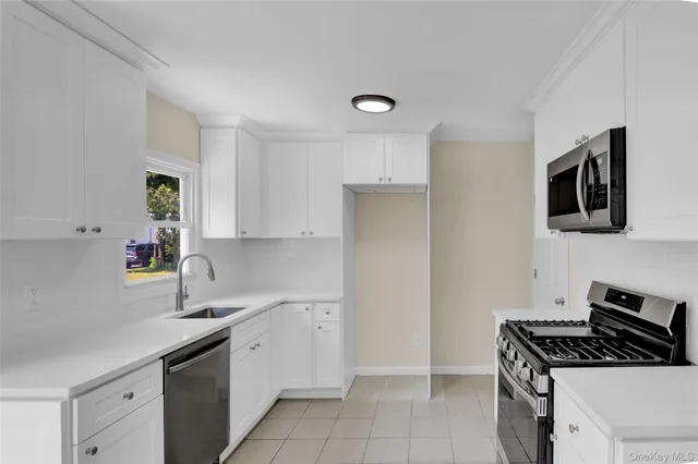 a kitchen with stainless steel appliances granite countertop a sink stove and cabinets