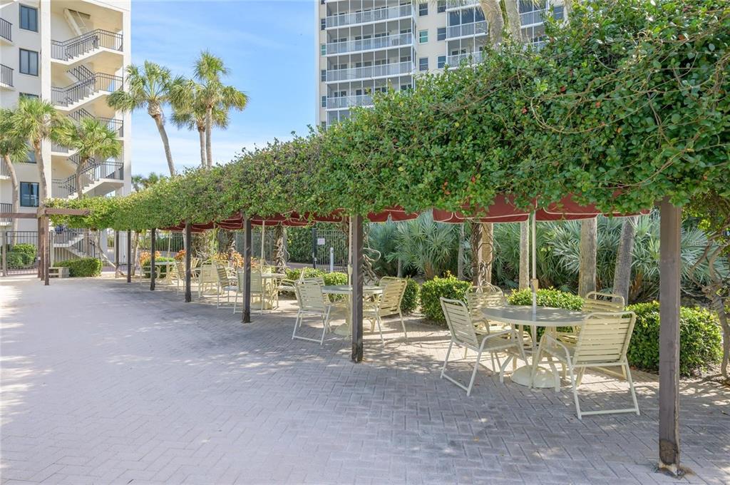 6285 Midnight Pass Road, Unit 403 Sarasota, FL 34242 - Photo 45 of 51 a view of a chairs with a patio