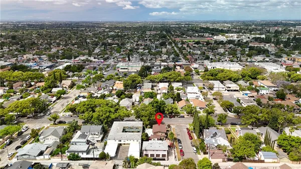 an aerial view of a residential houses with city view