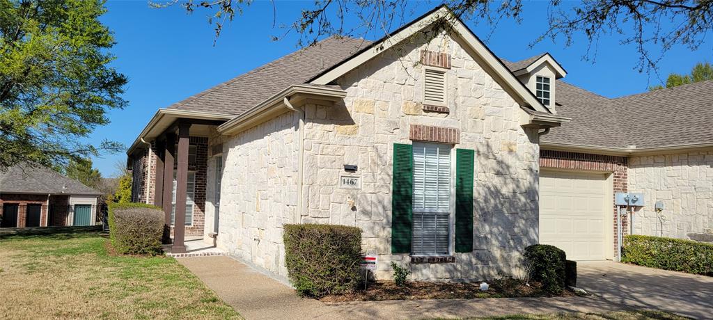 1467 Cattle Baron Court Fairview, TX 75069 - Photo 2 of 32 View of front facade with an attached garage, stone siding, a shingled roof, driveway, and a front lawn