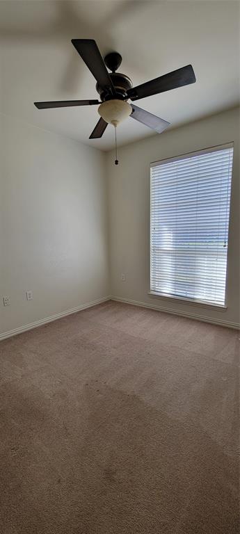 1467 Cattle Baron Court Fairview, TX 75069 - Photo 22 of 32 Empty room featuring light colored carpet and baseboards