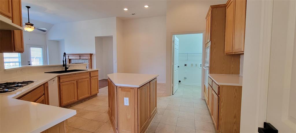 1467 Cattle Baron Court Fairview, TX 75069 - Photo 7 of 32 Kitchen with light countertops, ceiling fan, light tile patterned floors, lofted ceiling, and recessed lighting