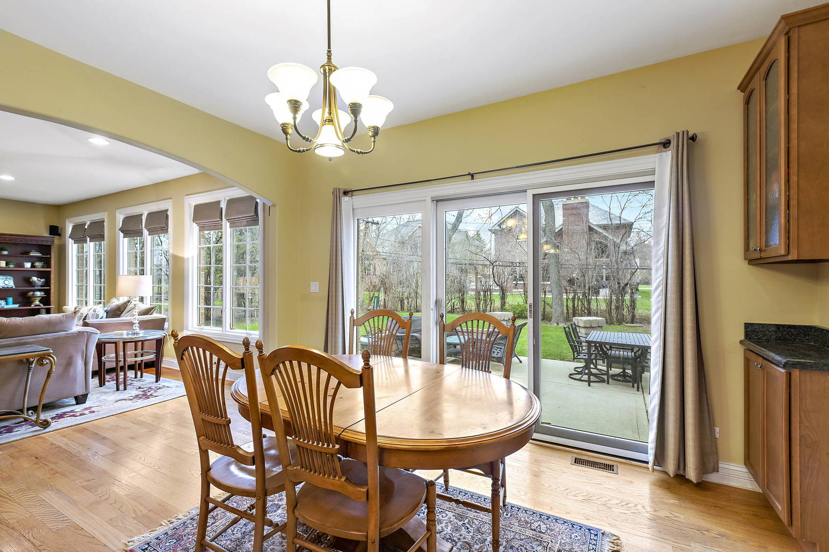 3206 Springdale Avenue Glenview, IL 60025 - Photo 6 of 20 a dining room with furniture a chandelier and wooden floor