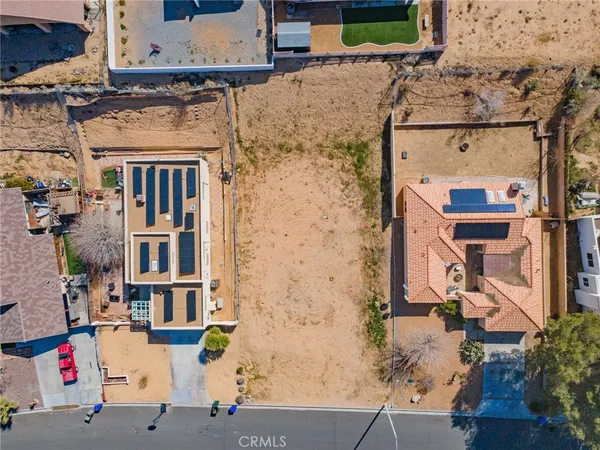 an aerial view of residential houses with outdoor space