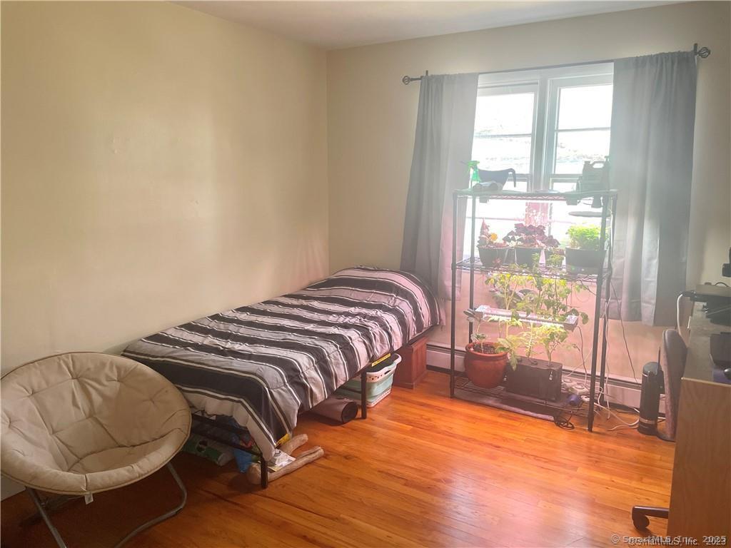 55 Oak Ridge Drive, Unit 60 New Haven, CT 06513 - Photo 12 of 16 a bedroom with a bed and glass door