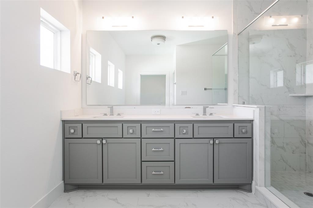 a bathroom with a sink vanity and mirror