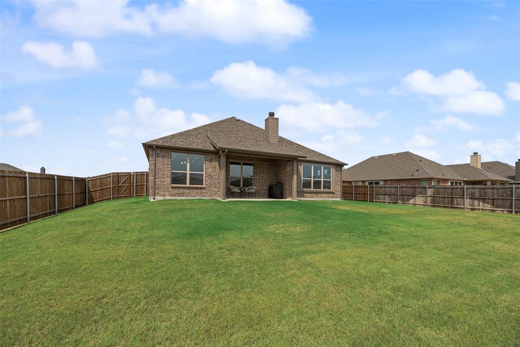 645 Mb Way South Pilot Point, TX 76258 - Photo 30 of 37 Spacious, fully fenced backyard with plenty of room to play, entertain, garden, or create your own outdoor retreat.