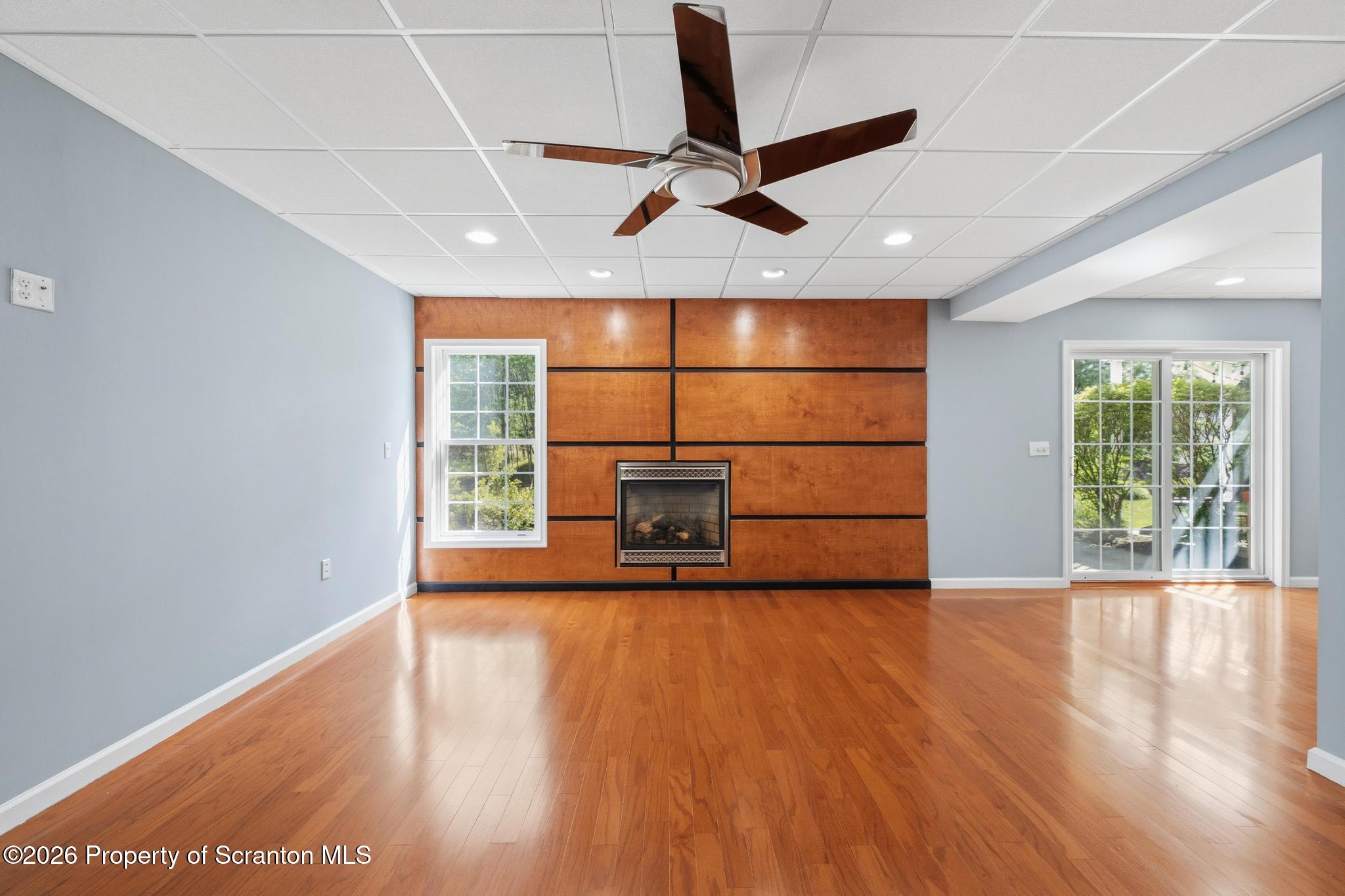 1502 Verne Cl Moosic, PA 18507 - Photo 32 of 46 a view of a livingroom with wooden floor a ceiling fan and windows