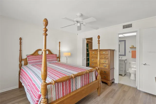 a bedroom with a bed next to a window