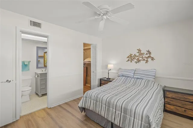 a bedroom with a large bed and a chandelier