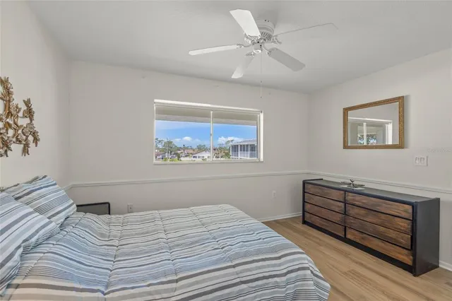 a bedroom with a bed and a painting on the wall