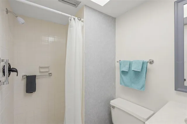 a white toilet sitting next to a white sink