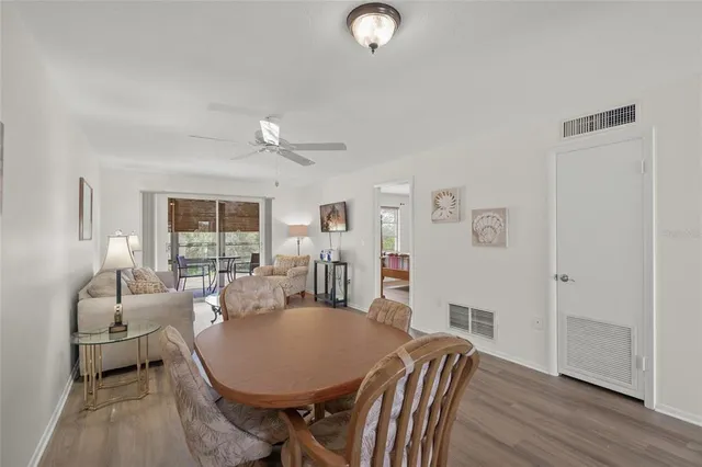 a living room with furniture a table and wooden floor